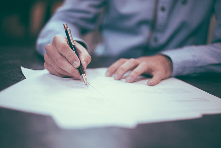 hand writing a letter on a desk from the FDA issuing warnings to CBD Companies for making unsubstantiated health claims