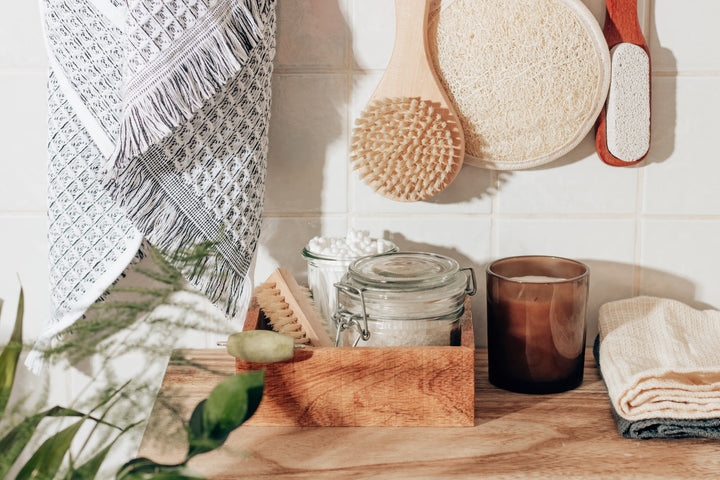 some products in a jar and some containers on a table next to a hung towel, plant, and cbd products that are unique that you likely have not tried